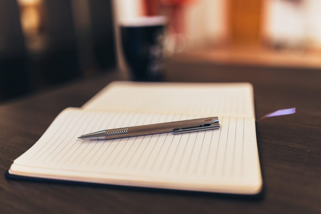 A notepad and pen on a desk